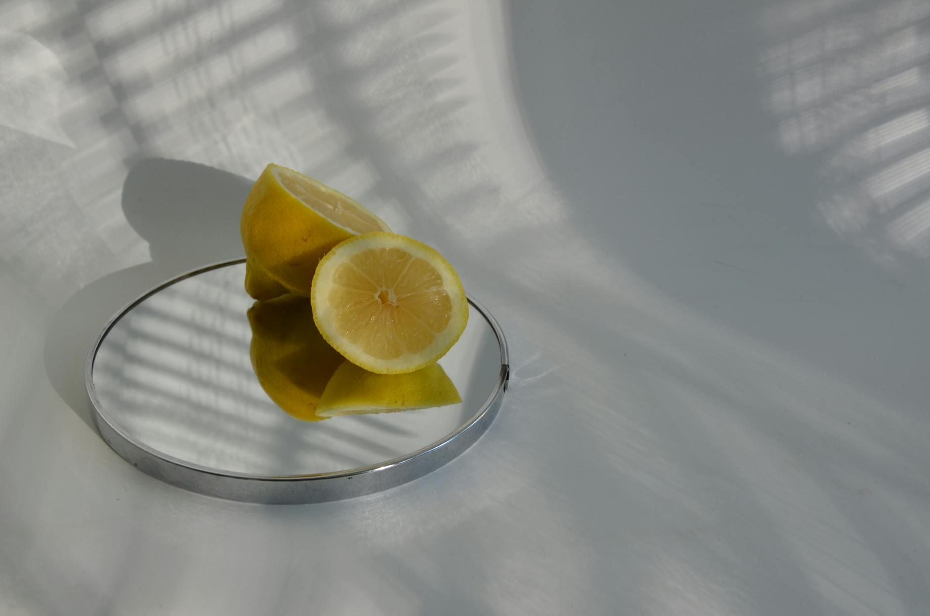 Sliced lemons on a mirror casting shadows, representing clarity during hormonal transition