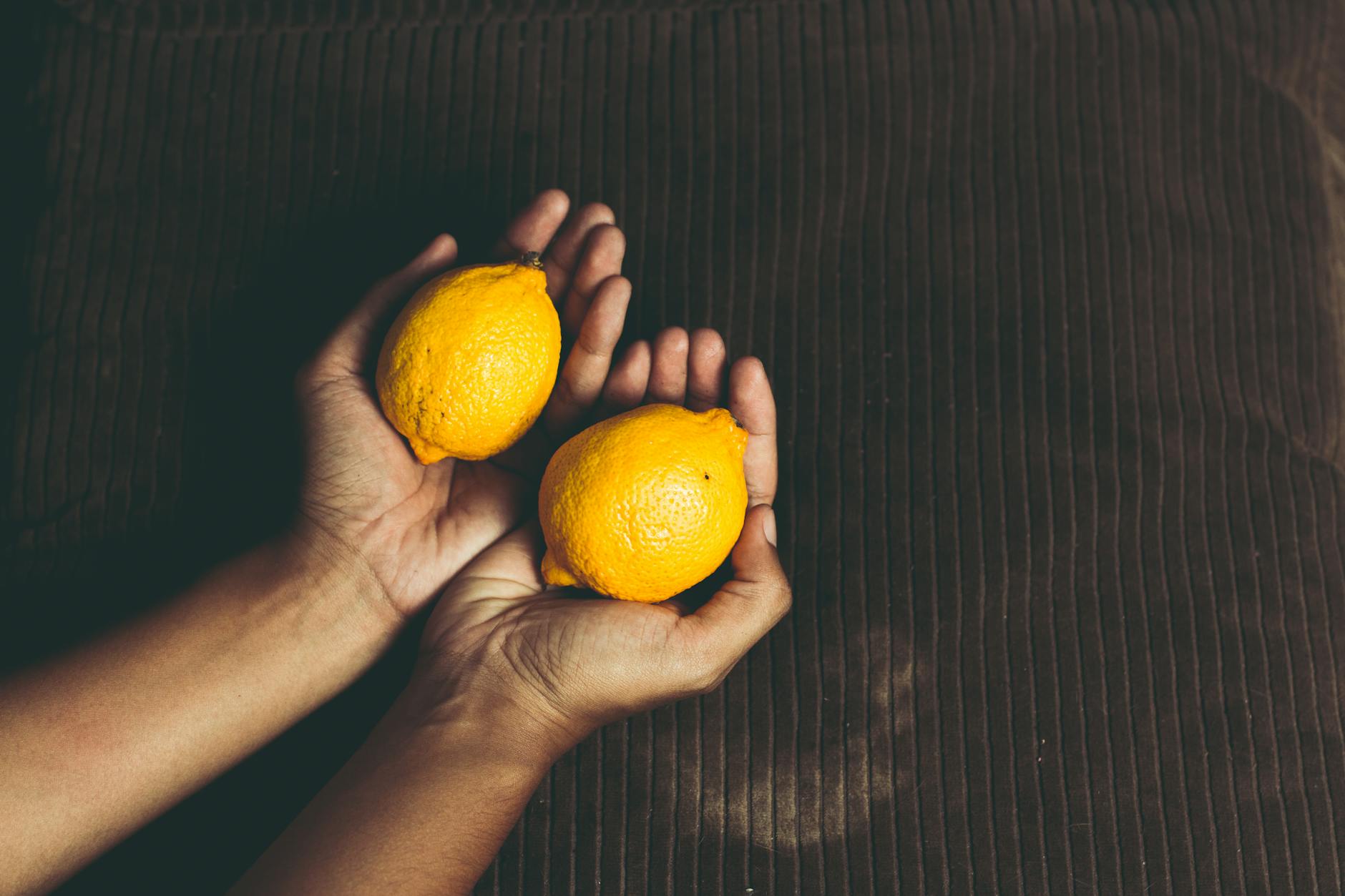 Bright yellow lemons arranged on a pastel background, symbolizing fresh approaches to intimate communication