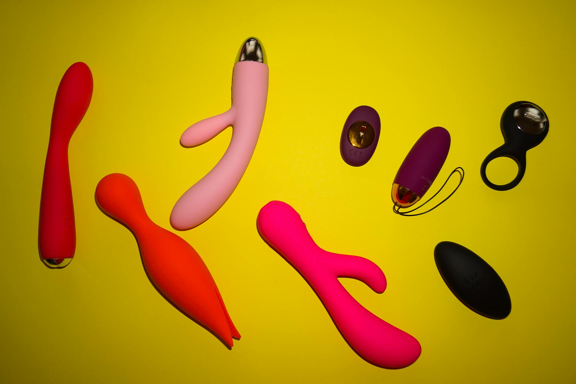 Close-up of hands holding a personal vibrator against a soft knitted sweater, representing intimate self-care and comfort.